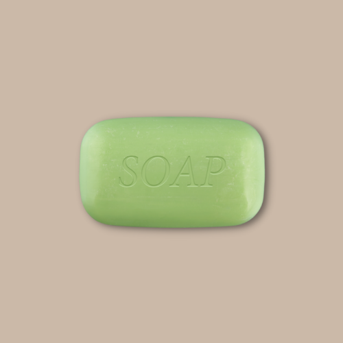 green soap bar against brown background