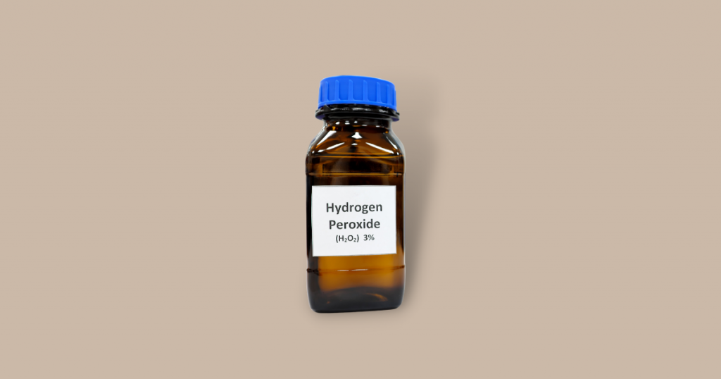 a bottle of hydrogen peroxide against brown background