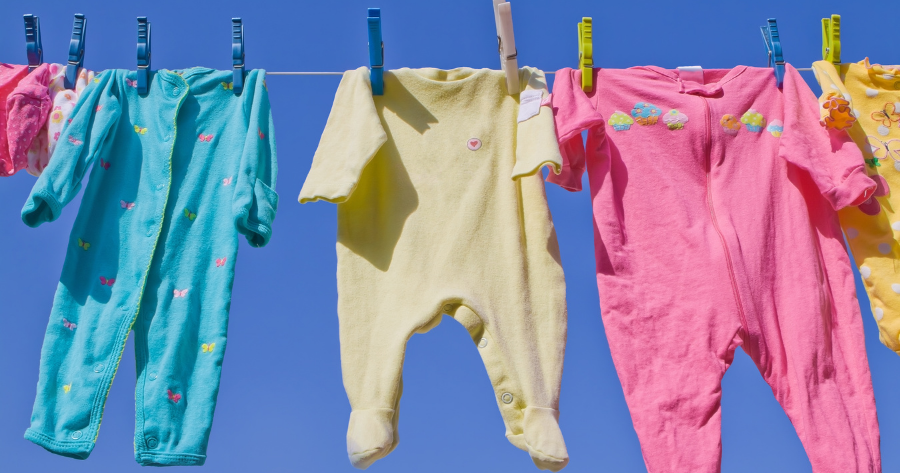 colorful baby clothes clipped to a clothesline