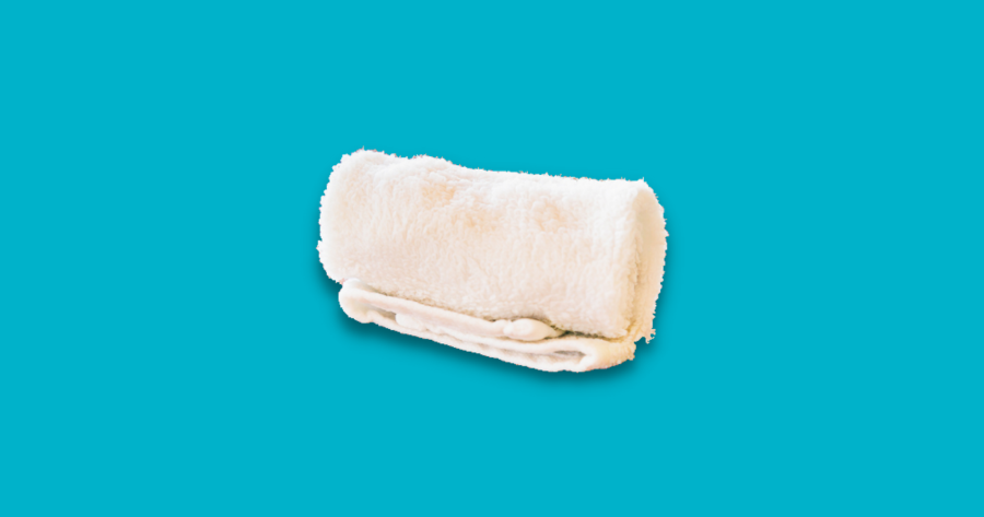 rolled white towel against blue background